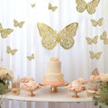 Elegant butterfly-themed cake display with gold accents and floral decorations.