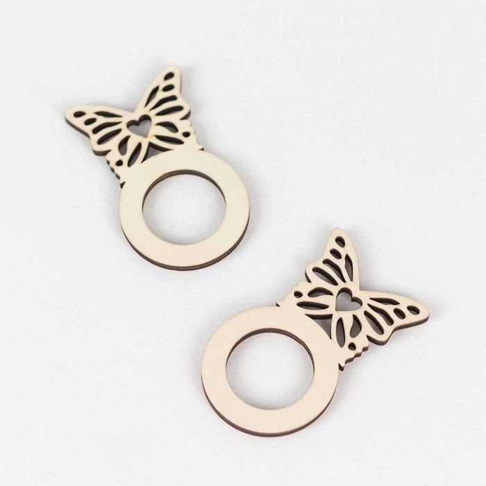 Butterfly-shaped wooden ring holders on a white background
