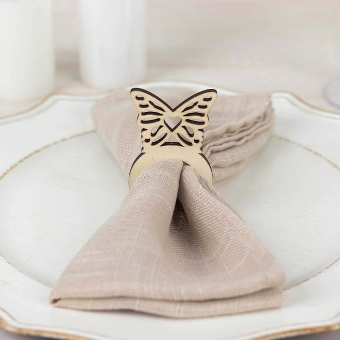 Butterfly napkin ring on a folded napkin on a decorative plate.