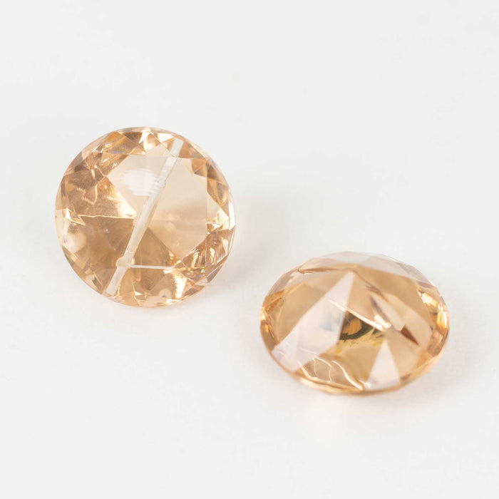 Peach-colored crystal gems with faceted surfaces