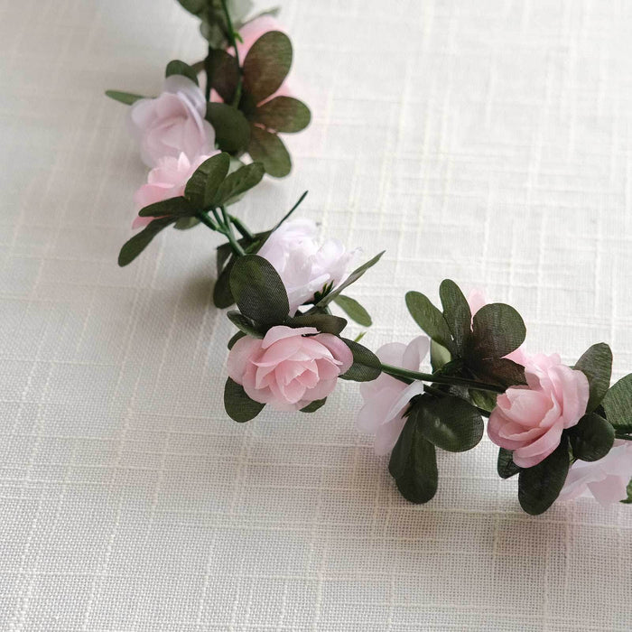 Floral crown with pink and white flowers and green leaves