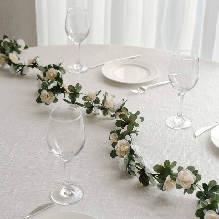 Elegant table setting with floral garland and glassware.