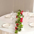 Elegant table setting with roses and glassware for a special occasion.
