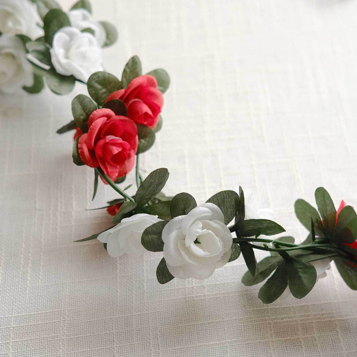 Floral crown with red and white roses and green leaves.