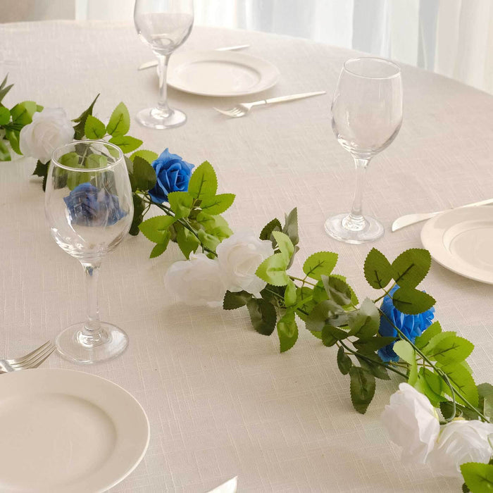 Table setting with floral garland, wine glasses, and plates.