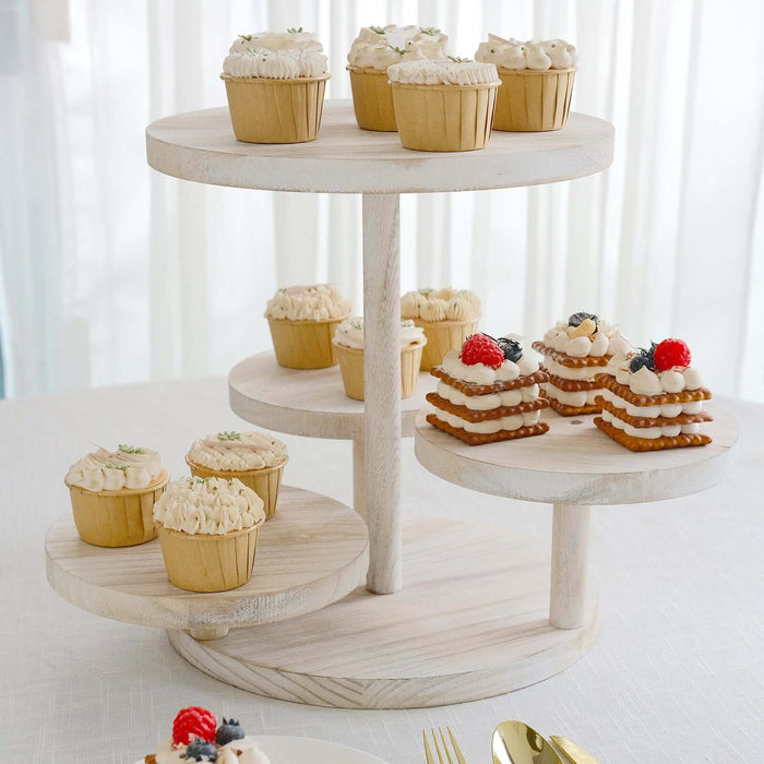 Three-tiered wooden serving stand with assorted cupcakes and desserts.