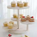 Three-tiered wooden serving stand with assorted cupcakes and desserts.