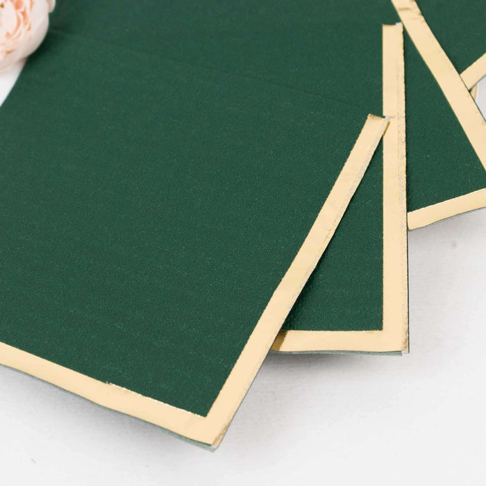 Green booklets with gold trim on a white background.