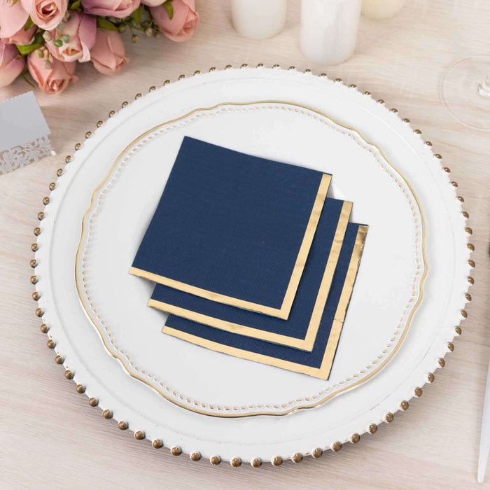 Navy blue napkins with gold trim on an elegant plate