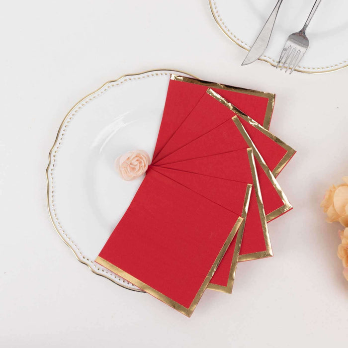 Red and gold edge blank invitation cards on a decorative plate.