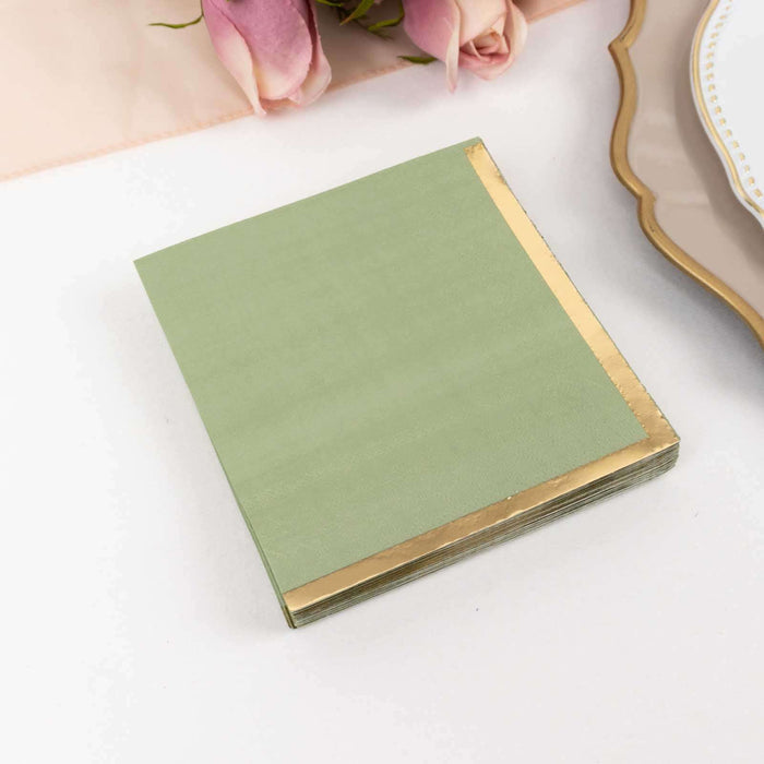 Green napkin with gold trim on a white background