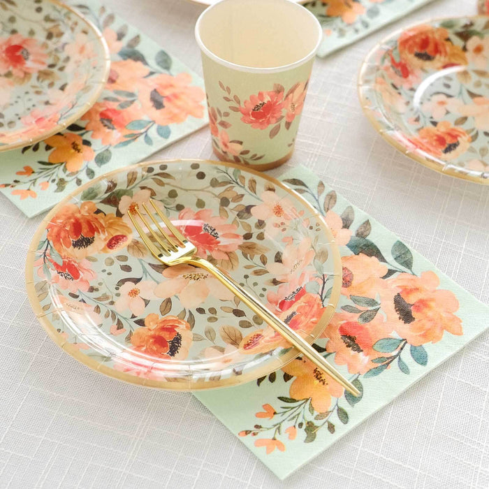 Floral disposable plates, cups, and napkins on a textured table setting.