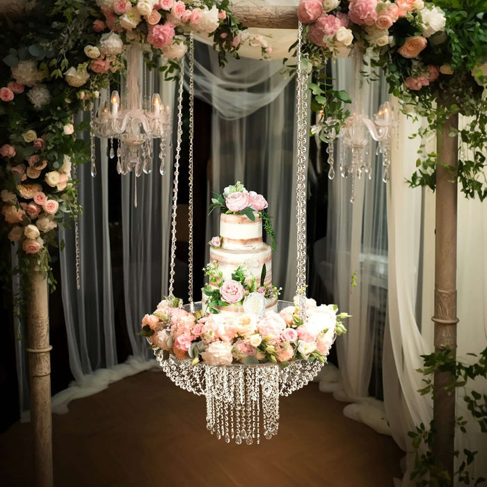 Hanging floral wedding cake display with pink roses and crystal accents.