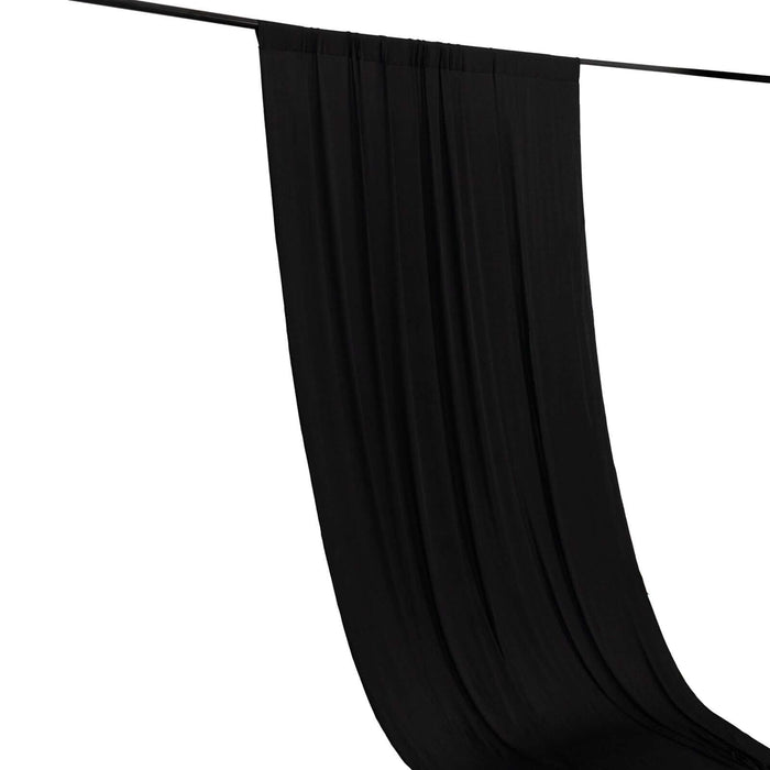 Black fabric drape hanging vertically against a white background.