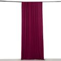 Maroon fabric curtain hanging from a rod against a white background