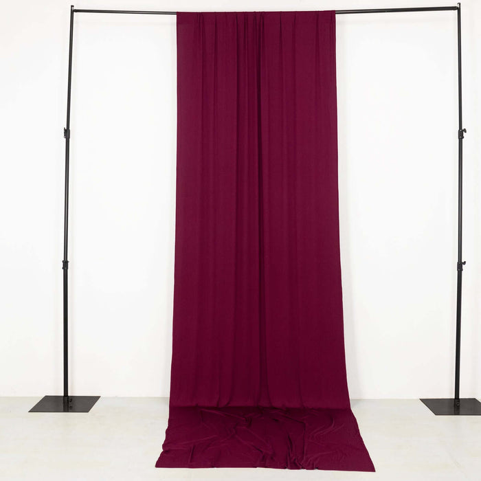 Burgundy fabric backdrop hanging from a black frame