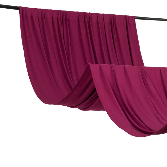 Magenta drapery fabric hanging elegantly on a rod
