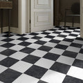 Classica black and white marble effect tiles laid in checkerboard effect on hall floor.