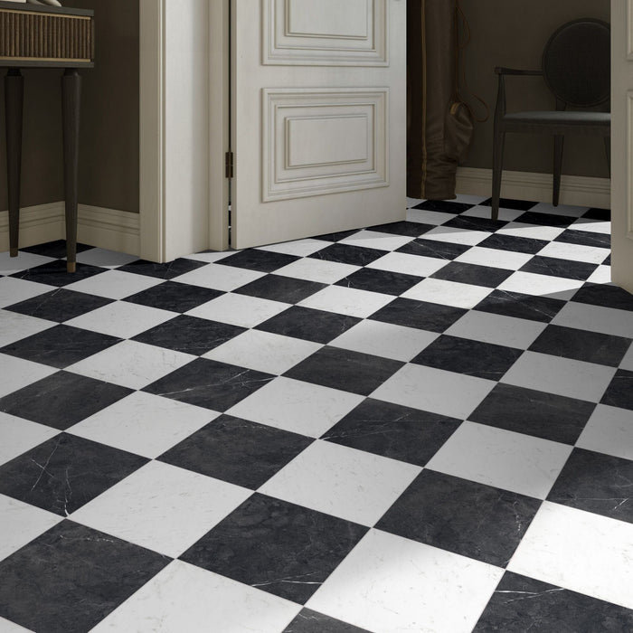 Classica black and white marble effect tiles laid in checkerboard effect on hall floor.