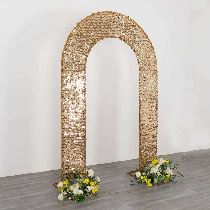 Gold sequin arch with floral decorations on a plain background.