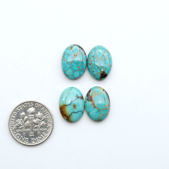 Hubei Cloud Mountain Turquoise cabochons, blue and green color with black matrix, polished stones on a white background, with a US dime for scale