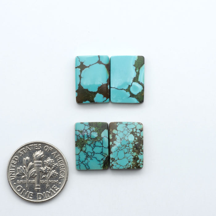 Hubei Cloud Mountain Turquoise cabochons, blue and green color with black matrix, polished stones on a white background, with a US dime for scale