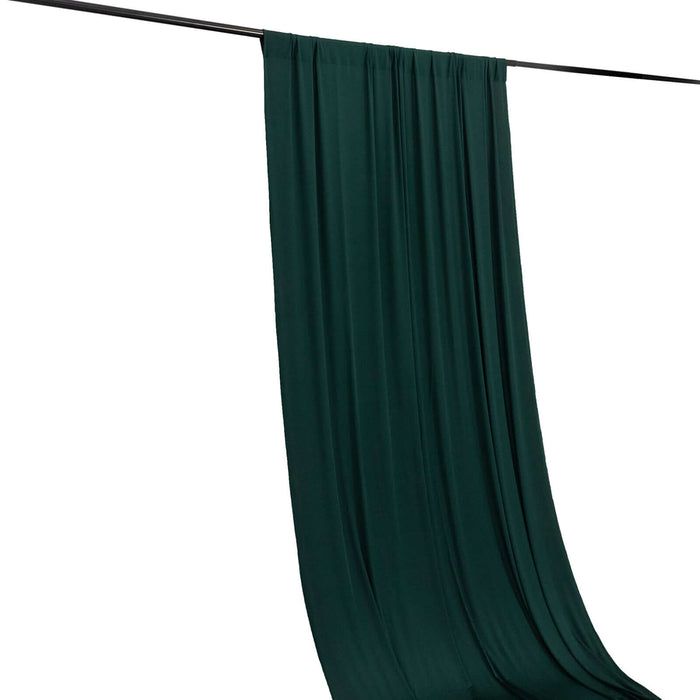 Dark green fabric draped elegantly on a rod