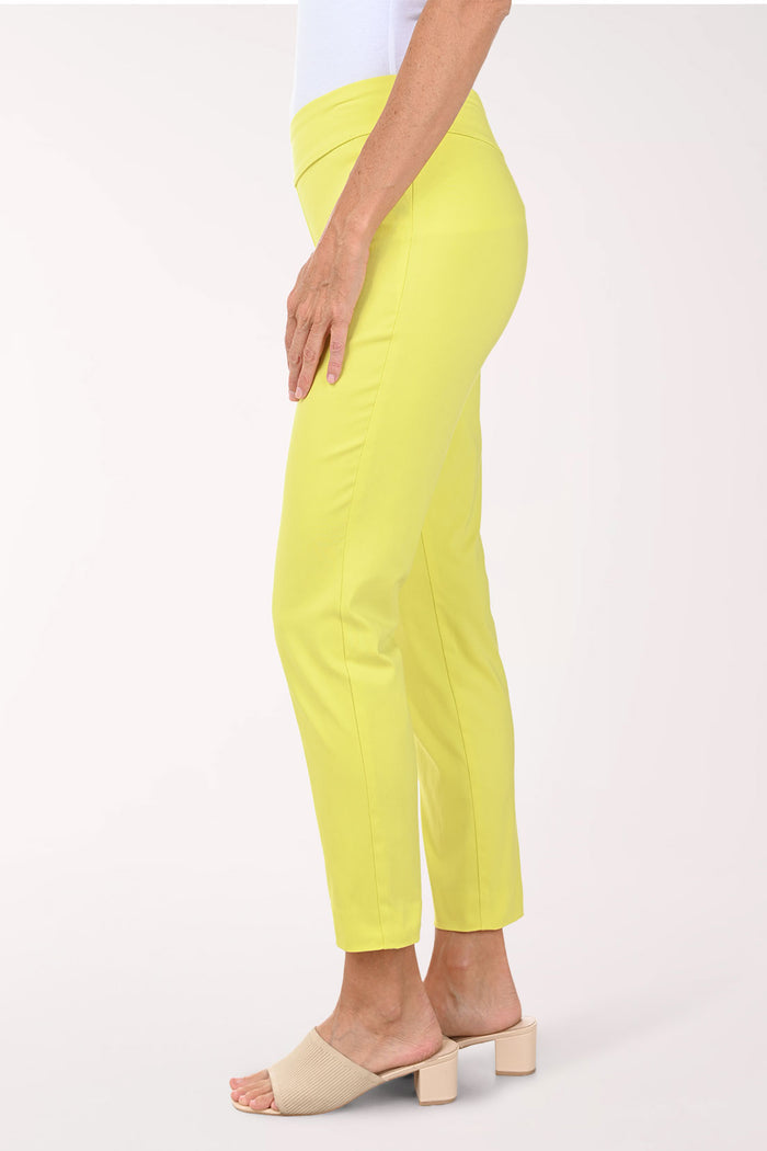 Person wearing bright yellow pants on a white background