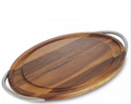 An oval-shaped carving board made of acacia wood with a chrome braid handle.