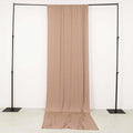 Beige fabric backdrop draped on a black support frame.