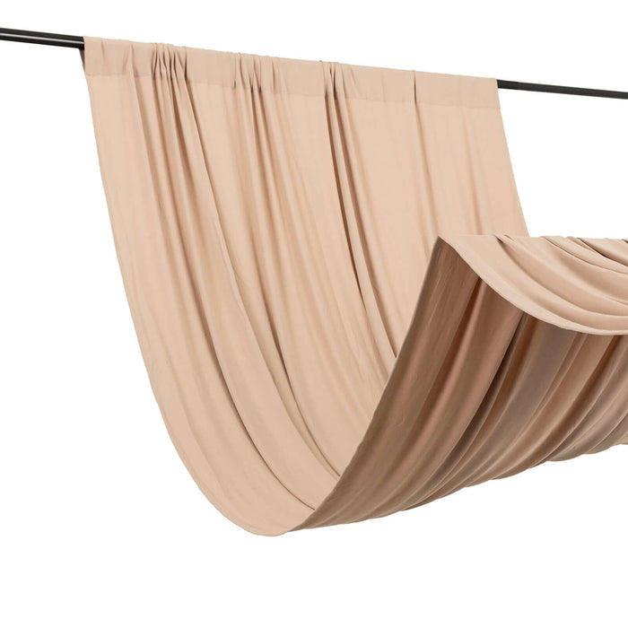Beige fabric draped on a rod, showcasing elegant folds and smooth texture.