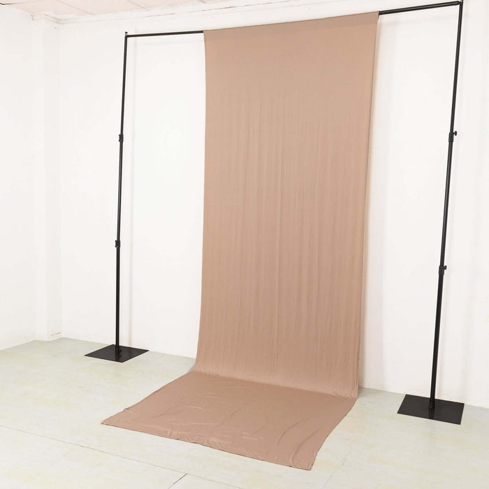 Beige backdrop fabric on a support stand for photography or events
