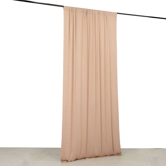 Peach fabric curtain draped on a rod against a plain white background