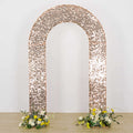 Rose gold sequin arch with floral arrangements at the base