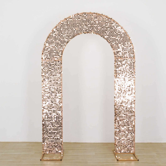 Rose gold sequin wedding arch on a plain background.