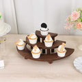 Wooden cupcake stand with seven decorated cupcakes displayed.