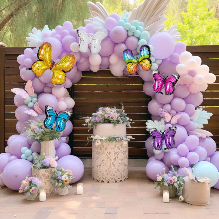 Colorful balloon arch with butterflies for a festive celebration setting.