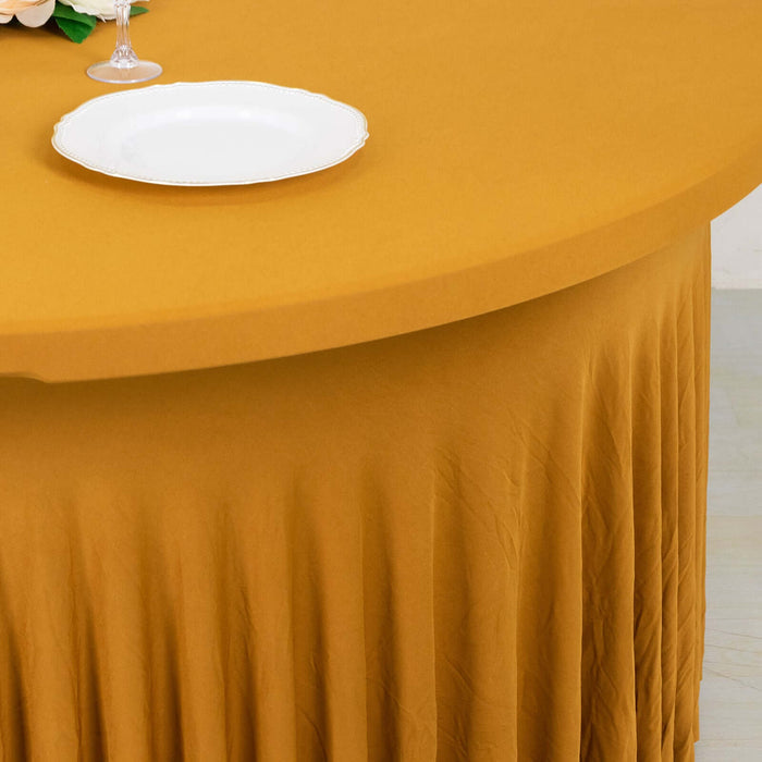 Yellow tablecloth with pleated design and white plate on a table.