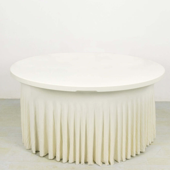 Round white table with a pleated cream skirt