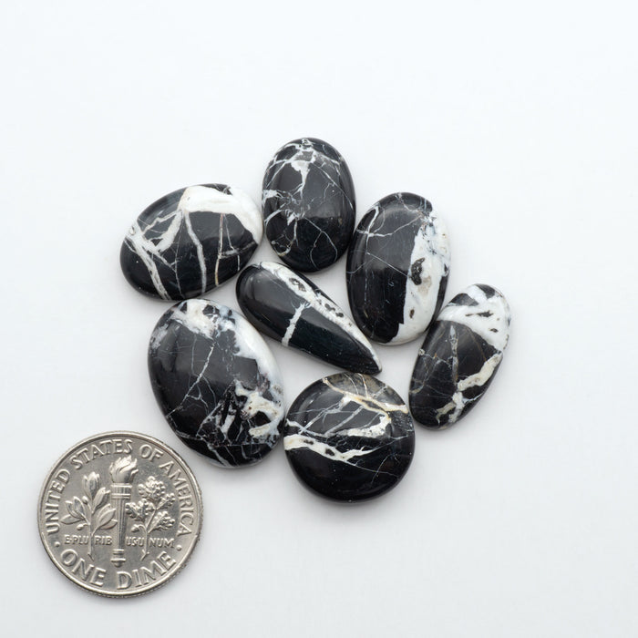 Natural White Buffalo Stone Cabochons are semi-precious gemstones cut into shapes ideal for jewelry-making, making them an excellent choice for artisans.