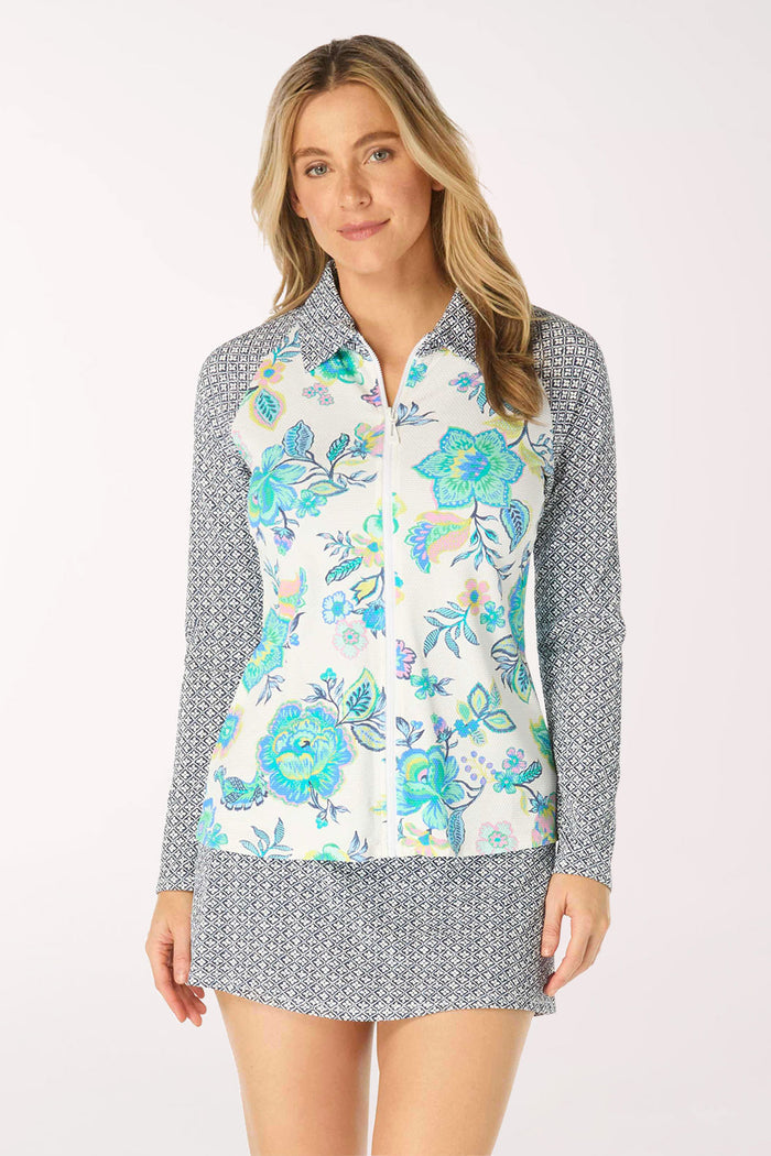 Woman wearing a floral rash guard with a patterned collar on a white background