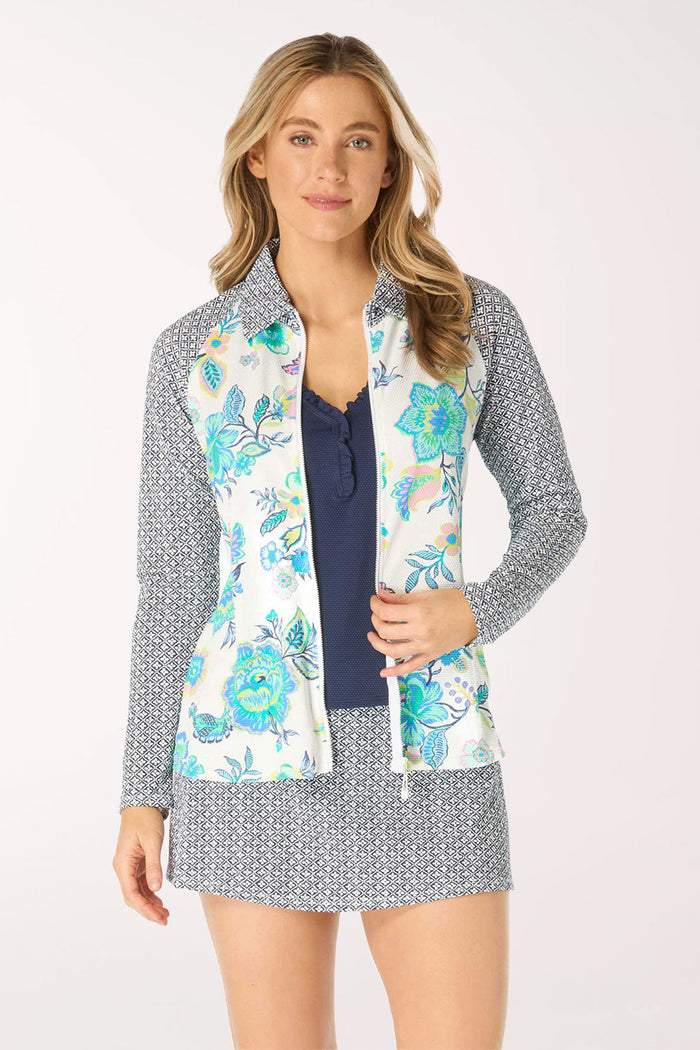 Woman wearing a floral rash guard with a patterned collar on a white background